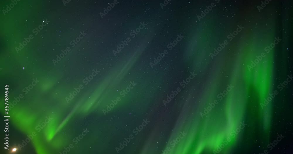 Low angle time lapse shot of green natural lights against stars in sky at night - Northwest Territories, Canada Low angle time lapse shot of green natural lights against stars in sky at night - Northwest Territories, Canada