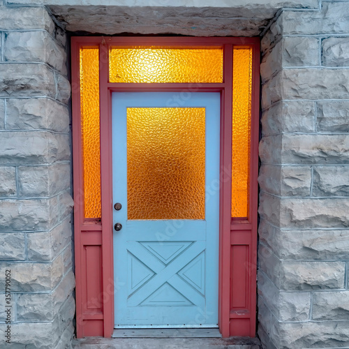 Square crop Frosted glass panes on the front door sidelights and transom window of home