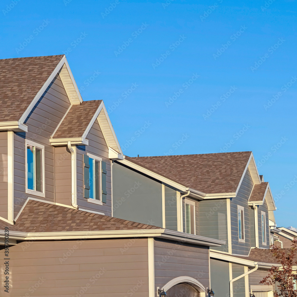 Square Row of houses in a suburb neighborhood with mountain and blue sky background Square Row of houses in a suburb neighborhood with mountain and blue sky background