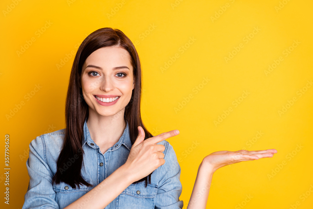 Portrait of positive cheerful girl hold hand point index finger copyspace indicate ads promotion wear good look clothes isolated over bright color background Portrait of positive cheerful girl hold hand point index finger copyspace indicate ads promotion wear good look clothes isolated over bright color background