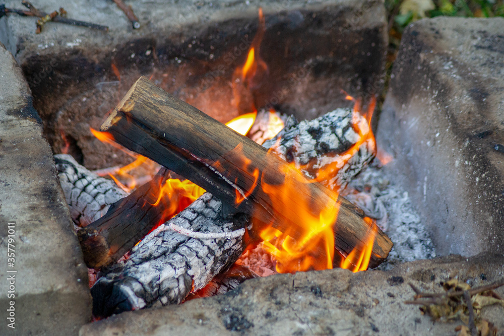 Bonfire in stacked stones. Burning wood in the fire and smoke. Bonfire in stacked stones. Burning wood in the fire and smoke.
