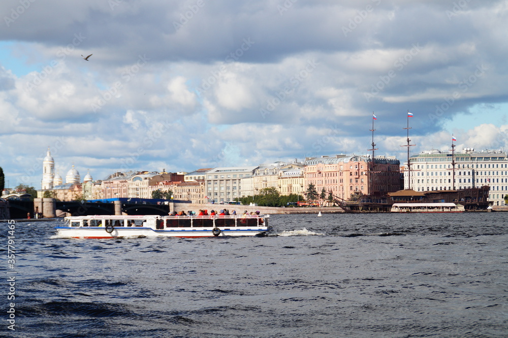 city on the banks of the Neva River and a pleasure boat on the water
