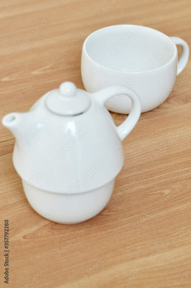 teapot and cup on wooden table teapot and cup on wooden table