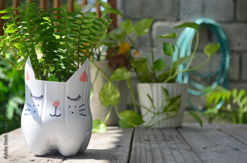 Recycled colored flower pots made of used plastic bottles. Nice decoration for inside and outside.