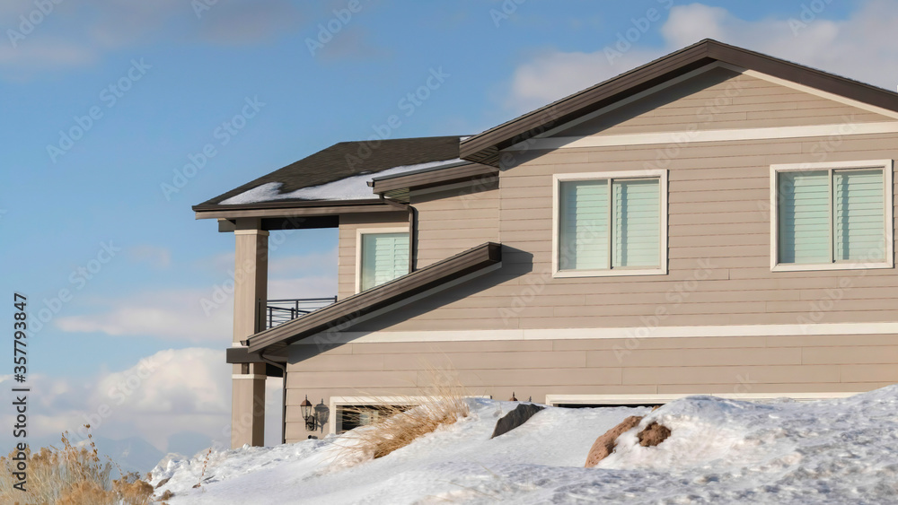 Panorama frame Home against cloudy blue sky at the snowy neighborhood of Wasatch Mountain Panorama frame Home against cloudy blue sky at the snowy neighborhood of Wasatch Mountain
