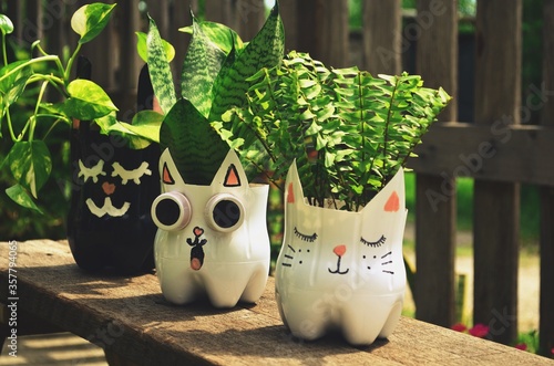 Recycled colored flower pots made of used plastic bottles. Nice decoration for inside and outside.