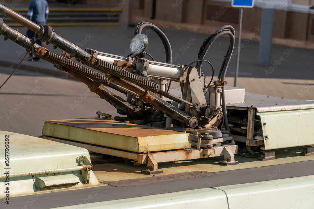 Fototapeta premium Close-up of trolleybus wires on the roof, side view image