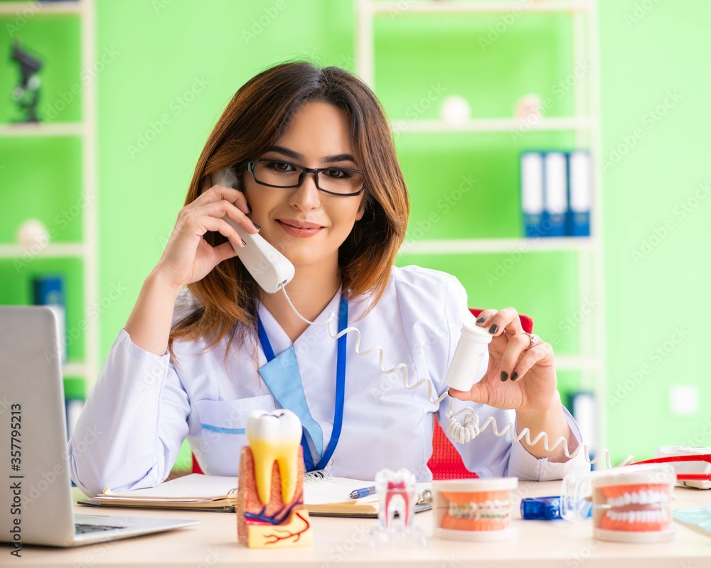 Woman dentist working on teeth implant Woman dentist working on teeth implant
