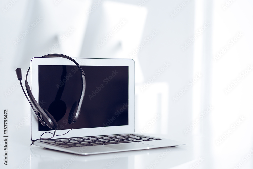 Fototapeta premium Call center and communication support, customer service help desk. VOIP headset on laptop computer