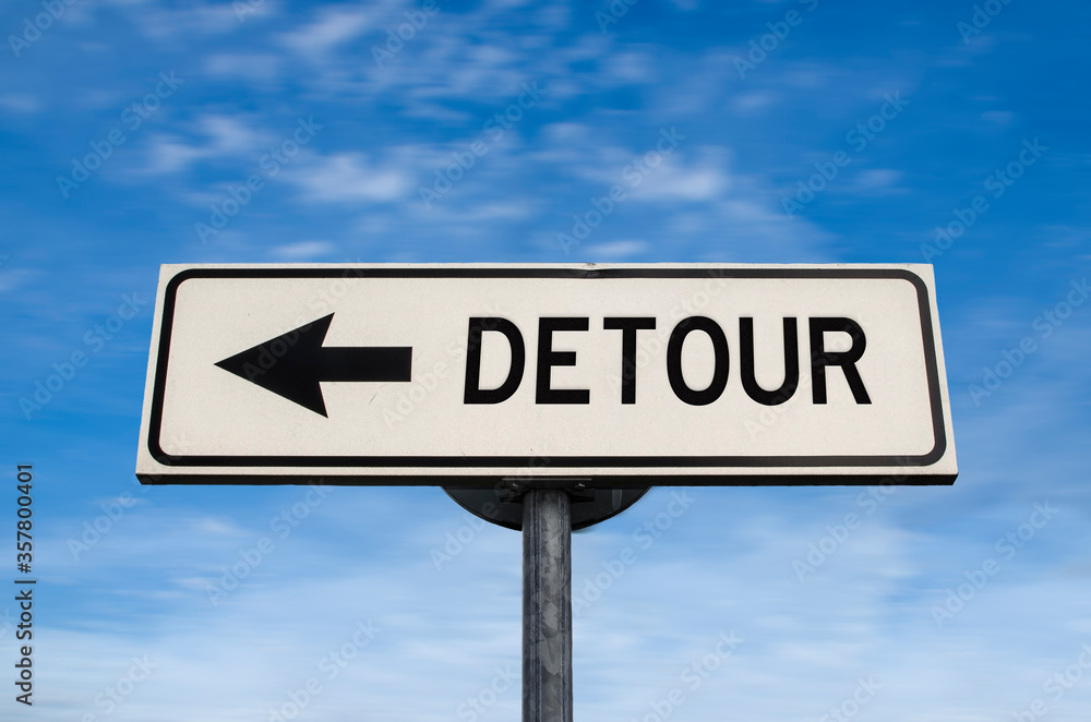 Detour road sign, arrow on blue sky background. One way blank road sign with copy space. Arrow on a pole pointing in one direction. Detour road sign, arrow on blue sky background. One way blank road sign with copy space. Arrow on a pole pointing in one direction.