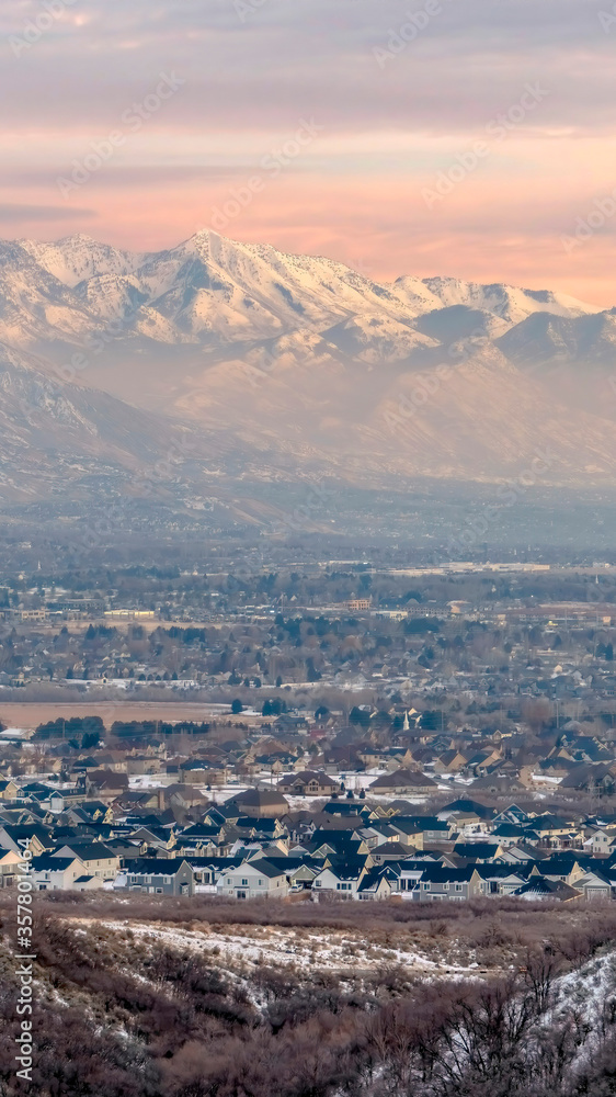 Vertical crop Stunning Wasatch Mountains and Utah Valley with houses dusted with winter snow