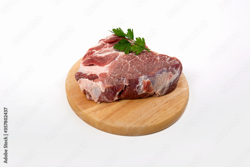 a piece of raw meat pork on a wooden backing a piece of raw meat pork on a wooden backing