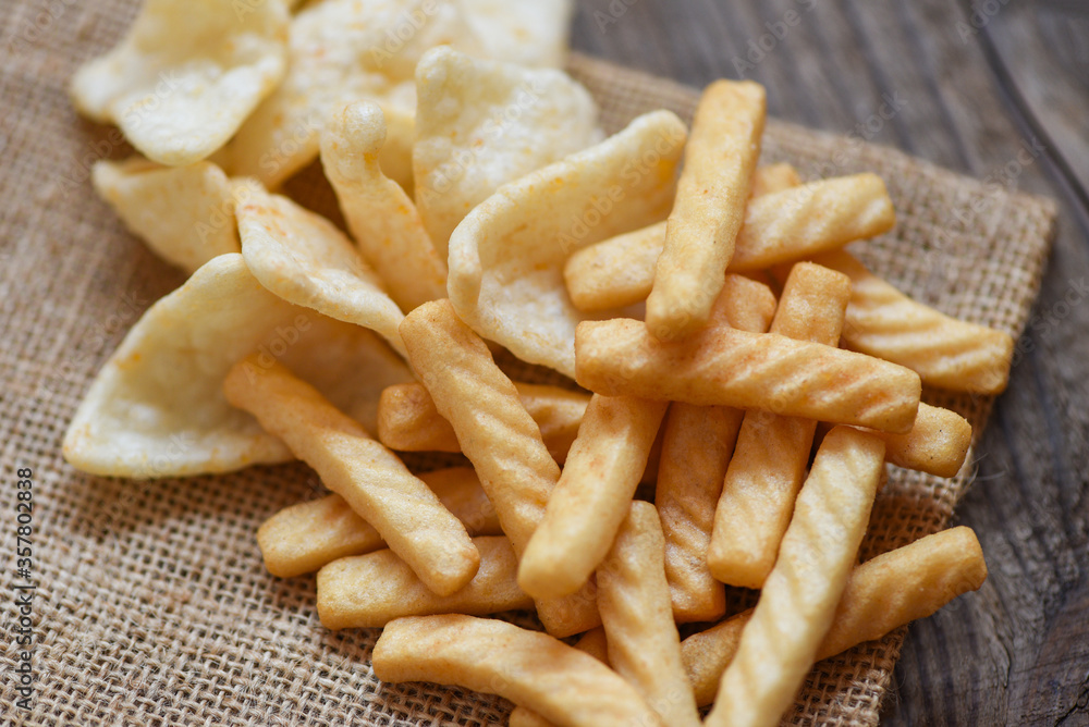 crunchy prawn crackers or shrimp crisp rice and ketchup for traditional  snack - prawn crackers stick on sack and wooden table background Stock  Photo | Adobe Stock