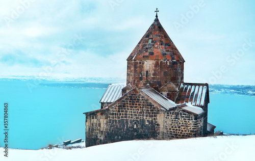 The ancient Armenian Sevanavank monastery beside the lake sevan in winter photo