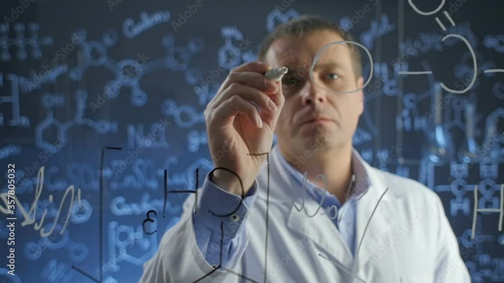 scientist chemist writes formulas on the glass scientist chemist writes formulas on the glass