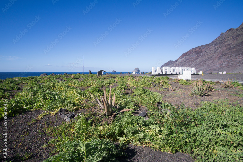 La Frontera El Hierro island Canary islands Spain on Dec 31, 2018: White letters on beach. La Frontera El Hierro island Canary islands Spain on Dec 31, 2018: White letters on beach.