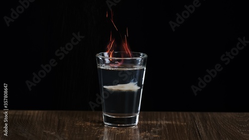 The bartender fire to an alcoholic cocktail with sambuca and Irish cream photo