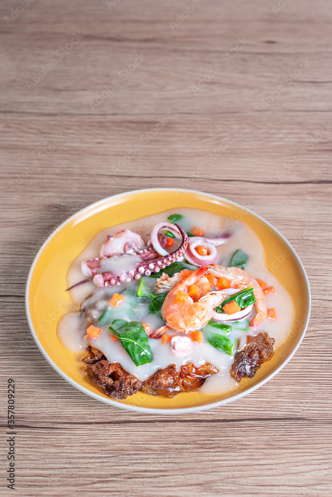 seafood and wide rice noodles in a creamy sauce seafood and wide rice noodles in a creamy sauce