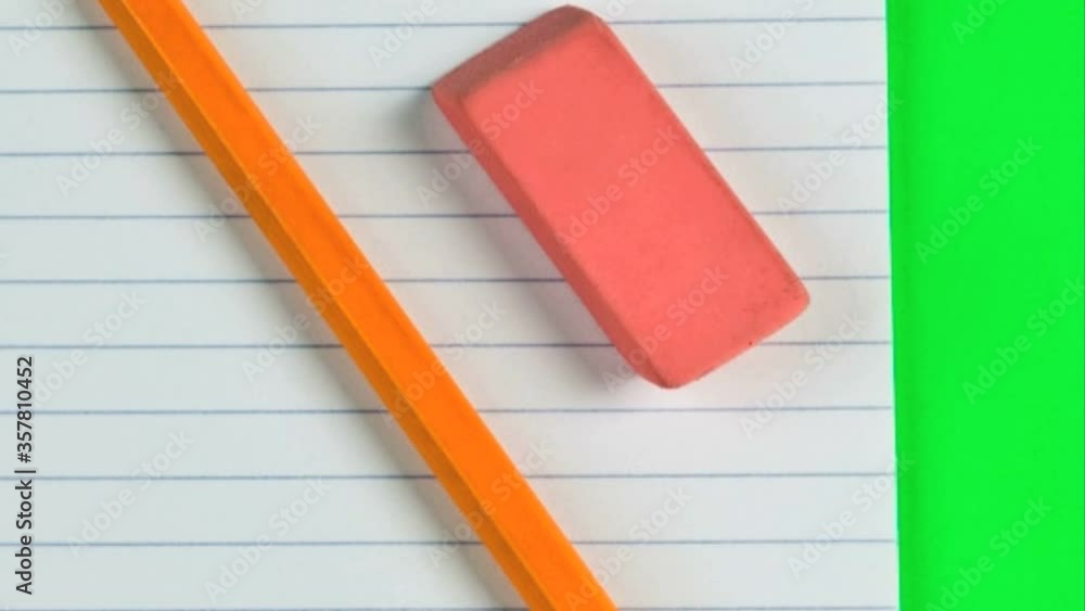 Pencil and eraser on a lined pad of paper Pencil and eraser on a lined pad of paper