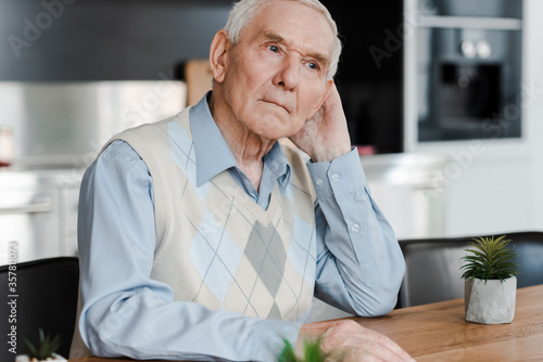 upset pensive elderly man at home during quarantine
