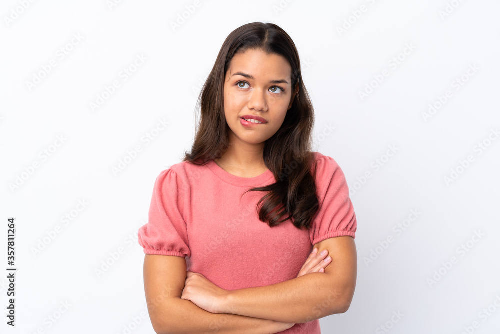 Young Colombian girl over isolated white background with confuse face expression Young Colombian girl over isolated white background with confuse face expression