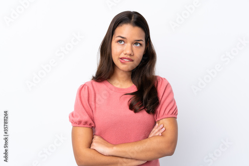 Young Colombian girl over isolated white background with confuse face expression © luismolinero