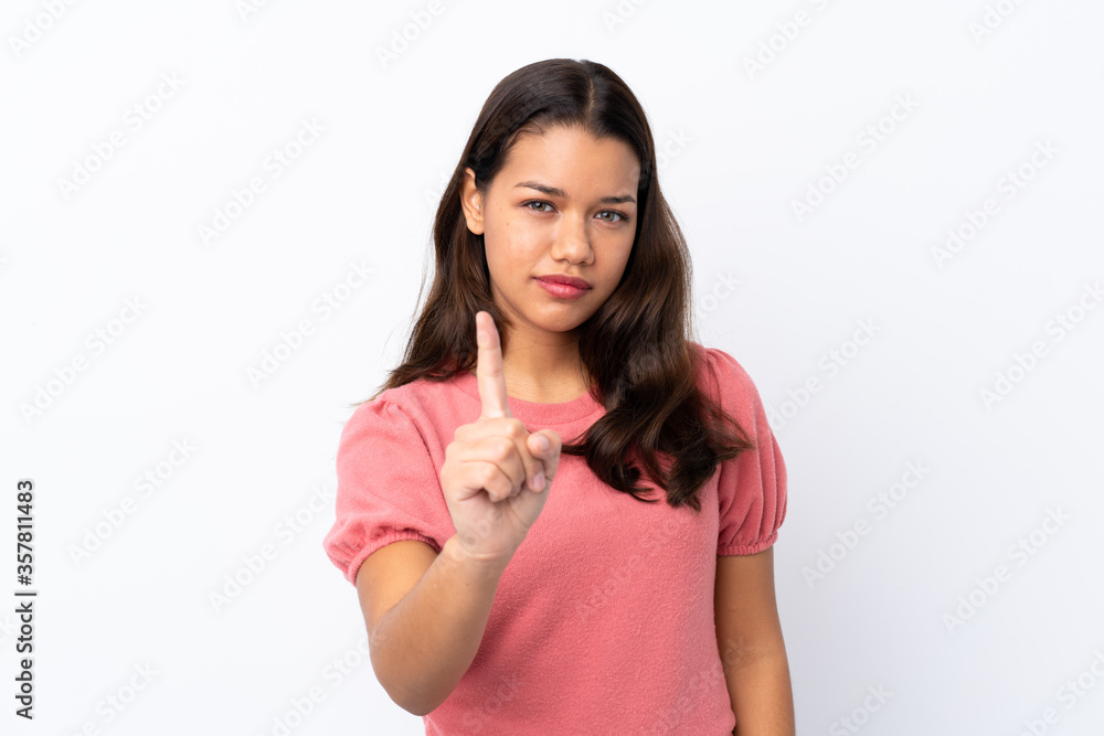 Young Colombian girl over isolated white background frustrated and pointing to the front Young Colombian girl over isolated white background frustrated and pointing to the front