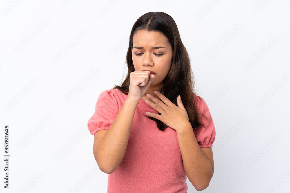 Young Colombian girl over isolated white background is suffering with cough and feeling bad Young Colombian girl over isolated white background is suffering with cough and feeling bad