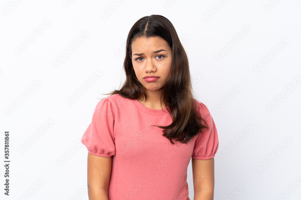 Young Colombian girl over isolated white background with sad and depressed expression Young Colombian girl over isolated white background with sad and depressed expression