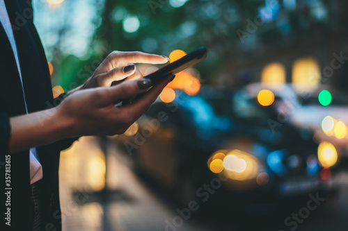 Fényképezés Traveler woman calling mobile phone waiting yellow taxi in evening street europe city Barcelona