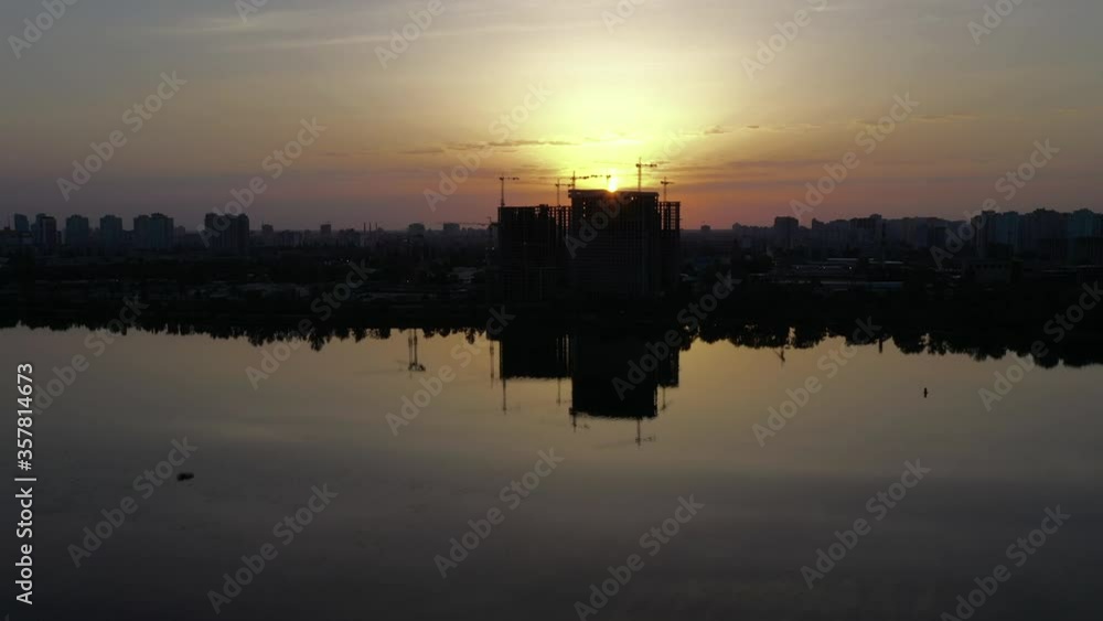 Horizontal panorama of the construction site with cranes against the backdrop of the industrial cityscape at dawn. Aerial Long Wide Shot on Mavic 2 Pro Drone. Horizontal panorama of the construction site with cranes against the backdrop of the industrial cityscape at dawn. Aerial Long Wide Shot on Mavic 2 Pro Drone.