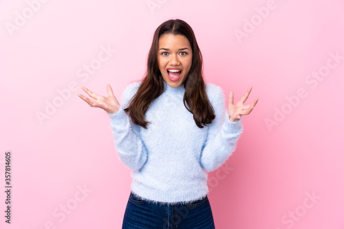Young Colombian girl over isolated pink background unhappy and frustrated with something © luismolinero