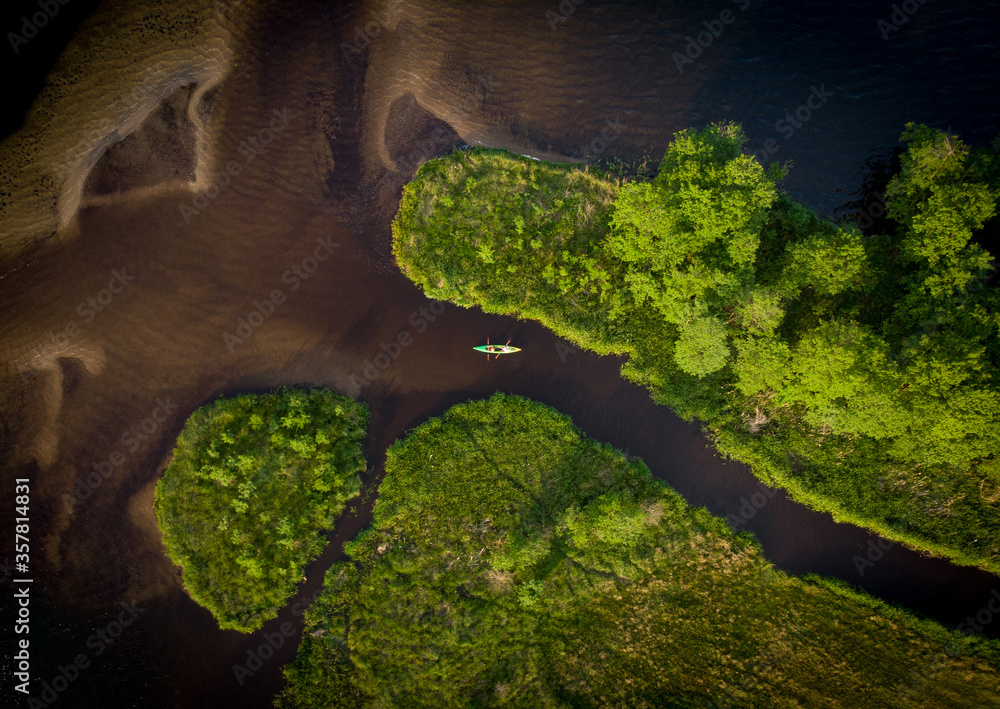 Picture of a canoe from a drone on one of the rivers in northern Poland (Kaszuby region near Swornegacie village). - obrazy, fototapety, plakaty 