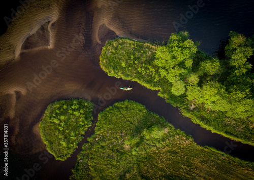 Picture of a canoe from a drone on one of the rivers in northern Poland (Kaszuby region near Swornegacie village).