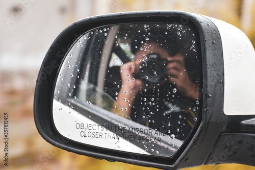 rear view mirror in car with person behind the camera