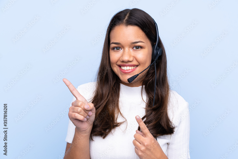 Young telemarketer Colombian woman over isolated blue background pointing finger to the side Young telemarketer Colombian woman over isolated blue background pointing finger to the side