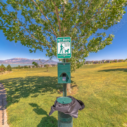 Square Dog poop bags and garbage can against timpanogos mountains and blue lake photo