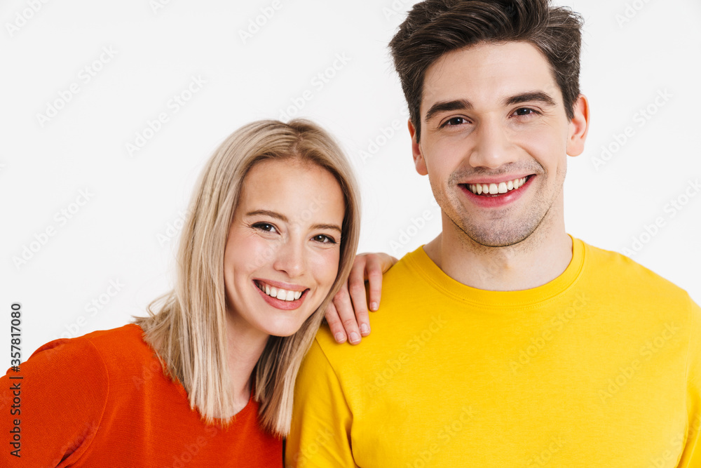 Image of cheerful young man and woman smiling and looking at camera Image of cheerful young man and woman smiling and looking at camera