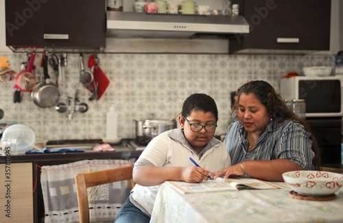 mother helps her son with schoolwork
