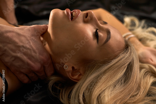 Bild auf Leinwand Close up portrait of a sexy young blonde with beautiful curly hair