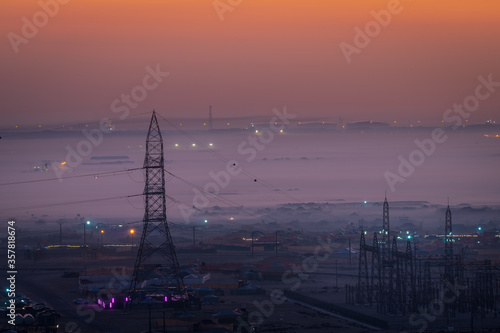 Beautiful sunrise foggy view of Sakhir camping area from a mountain in Bahrain.