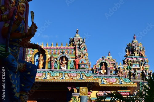 Details of a very colorful Hindu temple with many divinities represented.