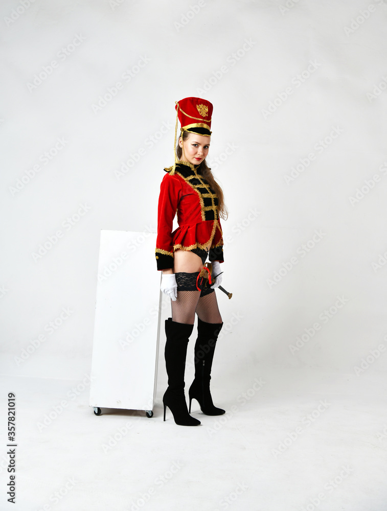 beautiful girl in a red hussar costume with a sword