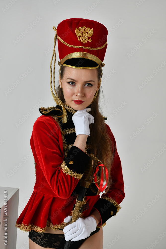 beautiful girl in a red hussar costume with a sword Stock Photo Adobe