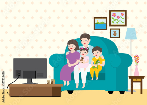 Happy Cute Family With Pyjamas Sitting On Sofa And Watching TV Together In A Living Room.