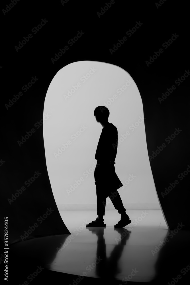 The silhouette of a man inside an tunnel