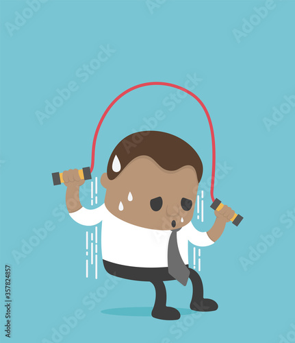 African businessman in a suit skipping a rope