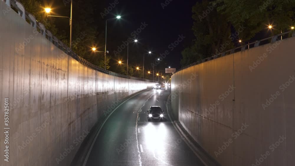 Crane rolling shot of a cars driving into a tunnel at night, Bucharest Crane rolling shot of a cars driving into a tunnel at night, Bucharest