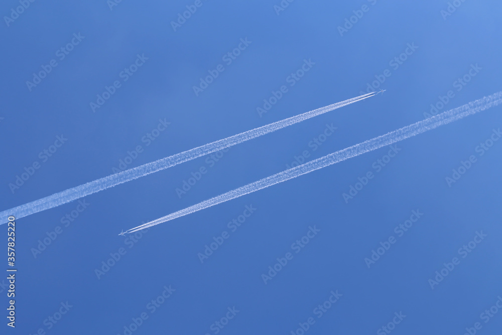 Trails from airplanes in the blue sky Trails from airplanes in the blue sky