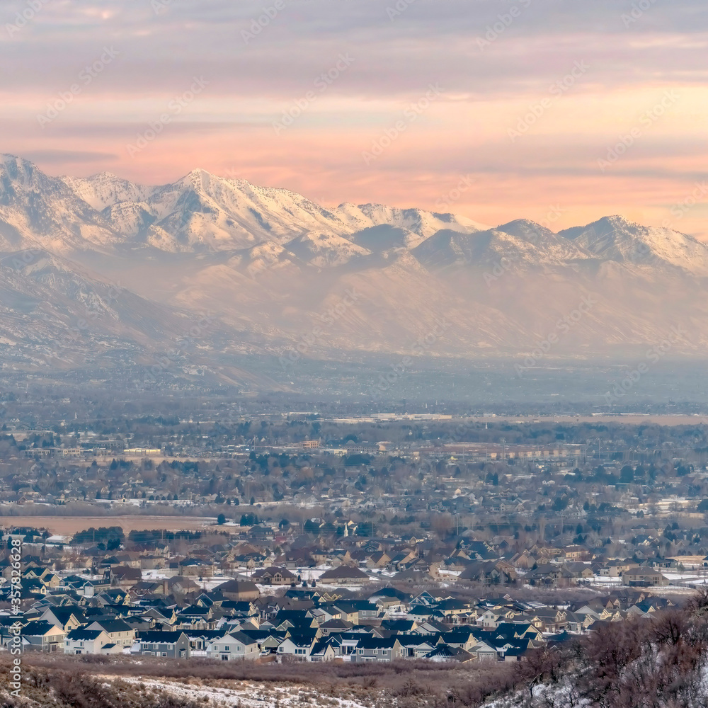 Square frame Stunning Wasatch Mountains and Utah Valley with houses dusted with winter snow